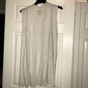 Long white sleeveless sweater vest.